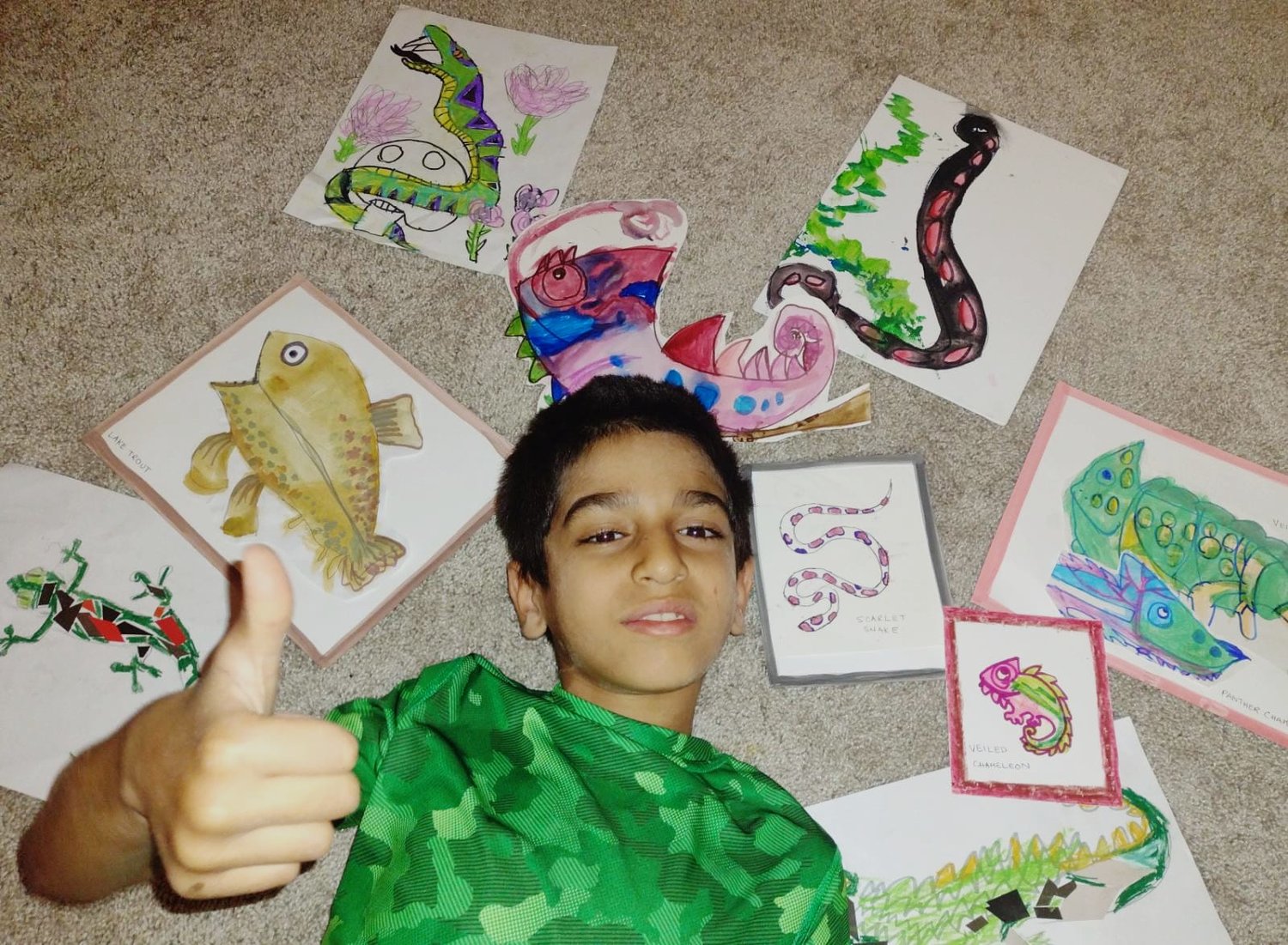 Khizar, a budding artist, poses with some of his artwork.
